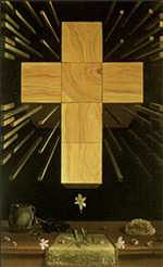 A large, wooden, yellow cross made of conjoined panels hovers over a table with flower and food. Wooden rods explode out from behind the cross in everything direction around it.